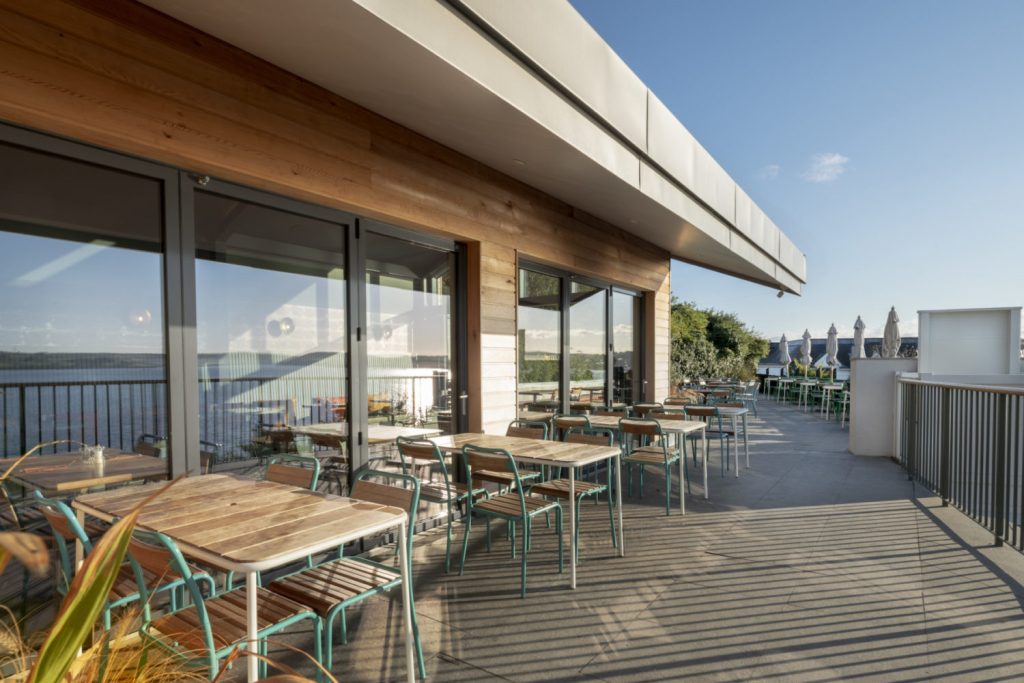Large areas of glazing fill the interior with natural light and open onto the terrace with panoramic views of the Camel Estuary